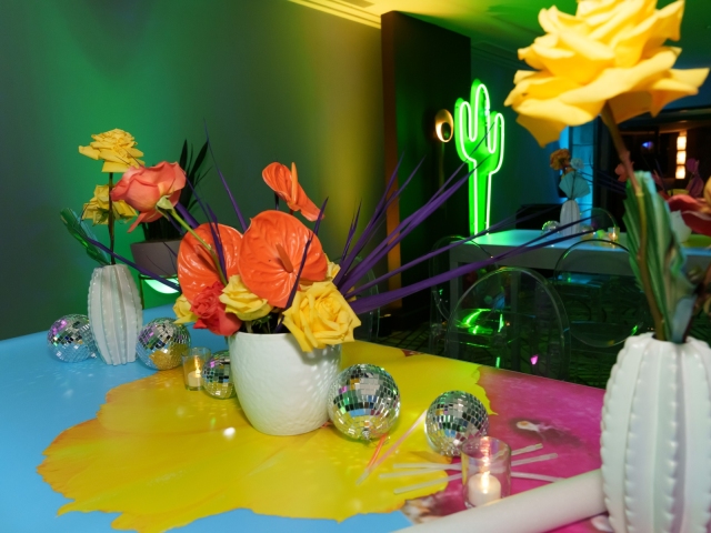 Bright floral centerpiece on table with disco balls.