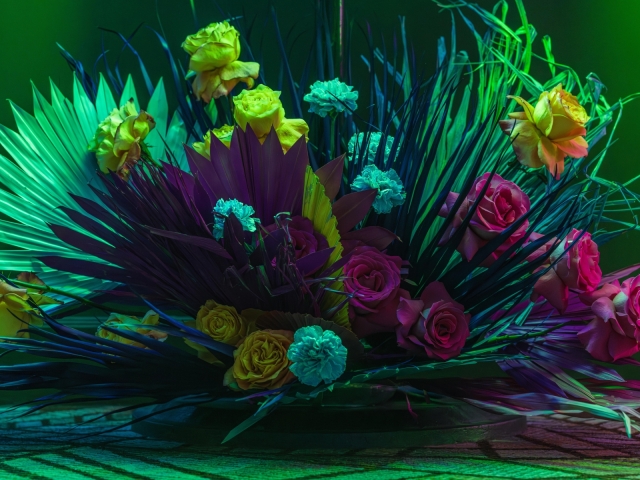 Large centerpiece with greenery and a variety of flowers.