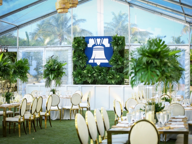 White and gold table and chairs featuring a view of the stage for incentive trip dinner in Bahamas.