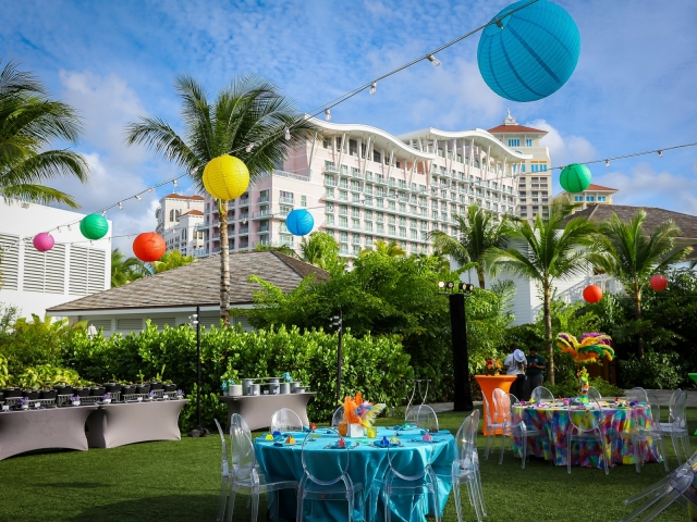 Full view of Junkanoo event tables and hotel with vibrant hanging lanterns