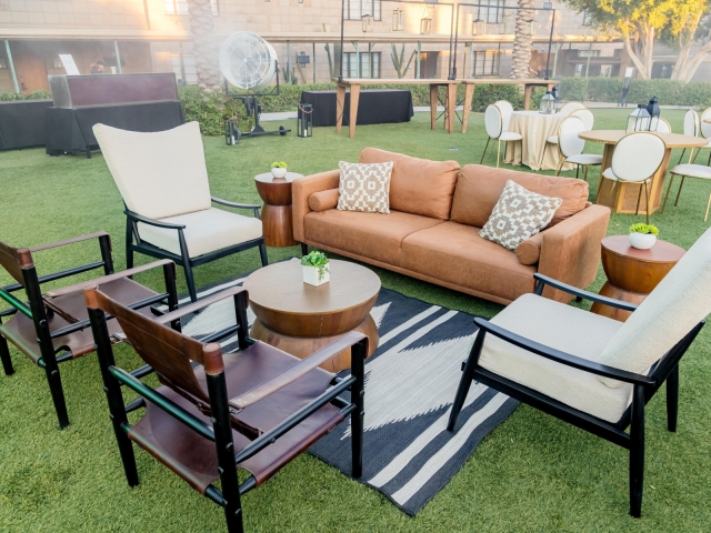 Lounge area at dessert reception with burnt orange couch and 4 lounge chairs.