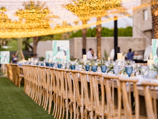 King table with hanging lights stretched across the event space.