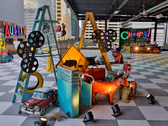 A display set up in Austin event space with a variety of signs, and Austin-themed objects.