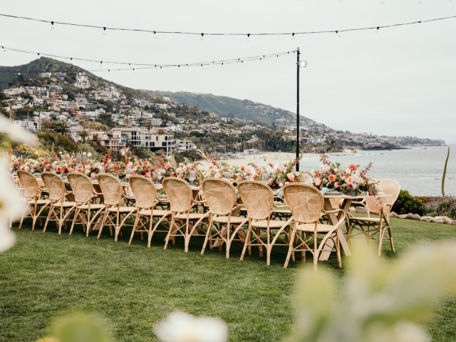 Outdoor  table set up overlooking ocean and view of Laguna Beach at President's Club Dinner.