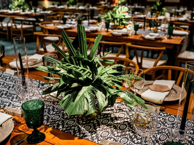 Green tropical plant on table with blue and white design table runner.