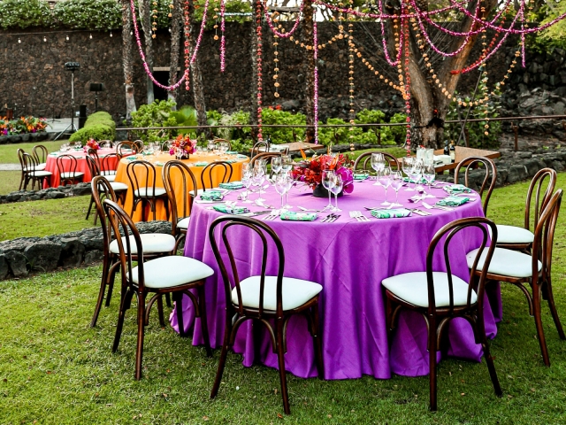 Yellow, purple and orange round tables for presidents club luau night.