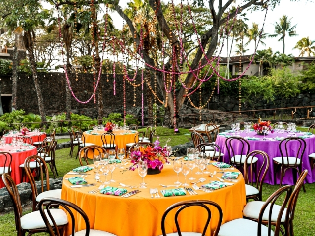 Yellow, purple and orange round tables for presidents club luau night.