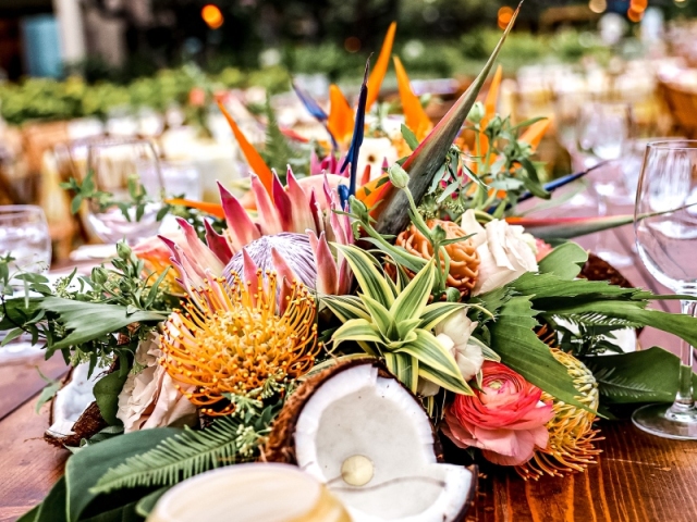 Floral centerpiece with Hawaiian flowers and coconut.