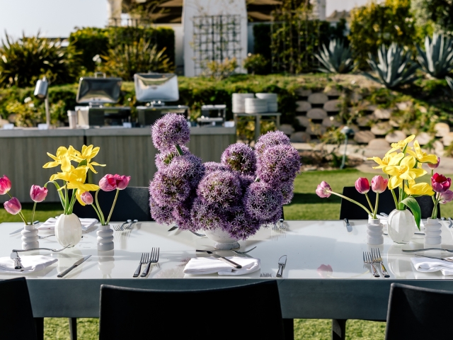 Close up of purple and yellow flower display on table