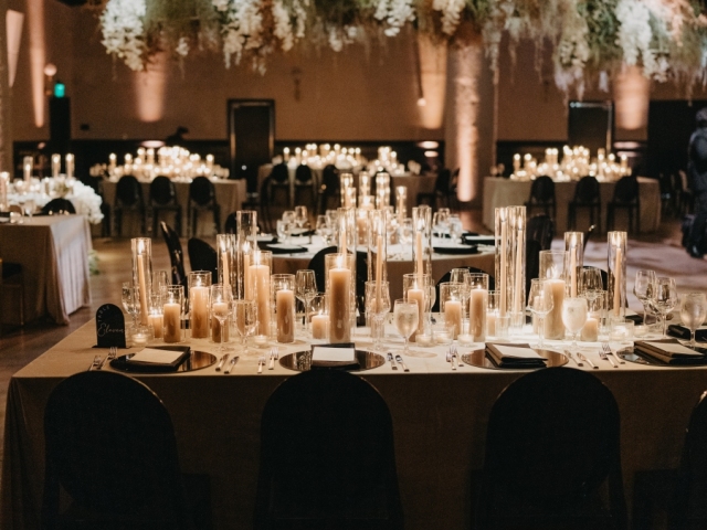 A beautiful table setting at wedding with white candles.