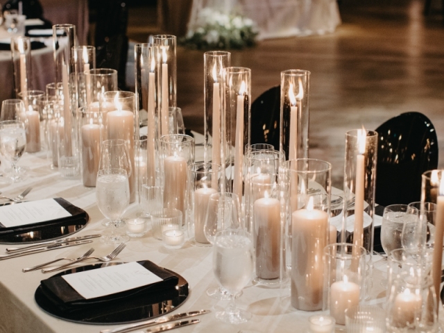 Close up of dinner setting at wedding with candles