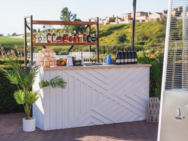 Pelican Hill white bar set up with shelf and green plant.