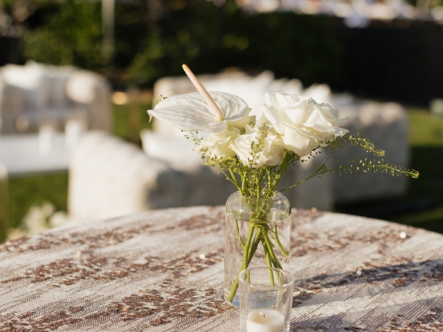 White classic flowers with baby breath  in a clear glass vase.