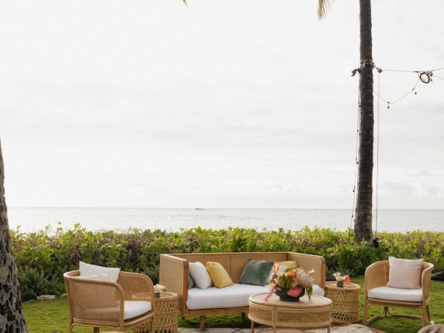 A full view of a lounge area at an event overlooking the ocean.