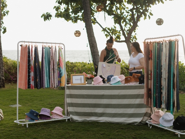 A table featuring hats and clothes for an influencer event.